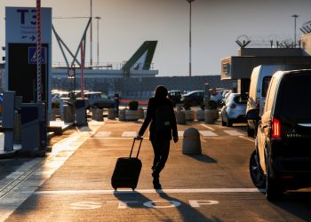 A passenger walks at Fiumicino airport after the Italian government announced all flights to and from the UK will be suspended over fears of a new strain of the coronavirus, amid the spread of the coronavirus disease (COVID-19), in Rome, Italy, December 20, 2020. REUTERS/Remo Casilli