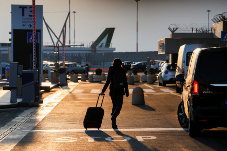 A passenger walks at Fiumicino airport after the Italian government announced all flights to and from the UK will be suspended over fears of a new strain of the coronavirus, amid the spread of the coronavirus disease (COVID-19), in Rome, Italy, December 20, 2020. REUTERS/Remo Casilli