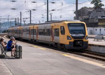 PORTO, PORTUGAL - JULY 06: A local train moves by while tourists wait for the Alfa Pendular high speed train, connecting Porto with Lisbon, at Campanha train station on July 06, 2018 in Porto, Portugal. Large numbers of visitors and locals travel by means of railroads between Porto, second largest city in the country, and Lisbon, its capital city. Portuguese tourist industry is going through a continuos boom, for the country is rated as very safe by travelers. (Photo by Horacio Villalobos - Corbis/Corbis via Getty Images)