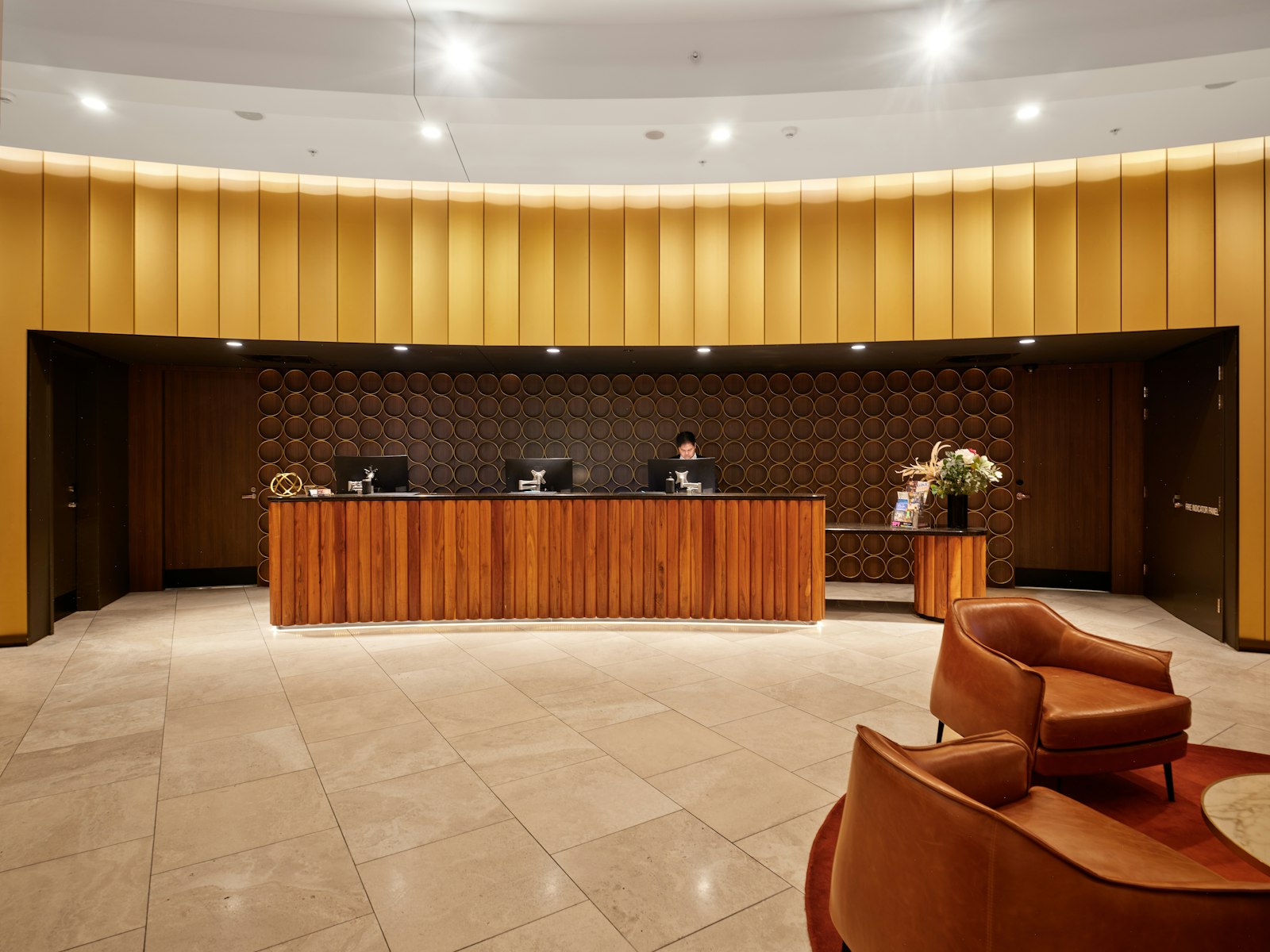 Modern reception desk with warm wood panelling