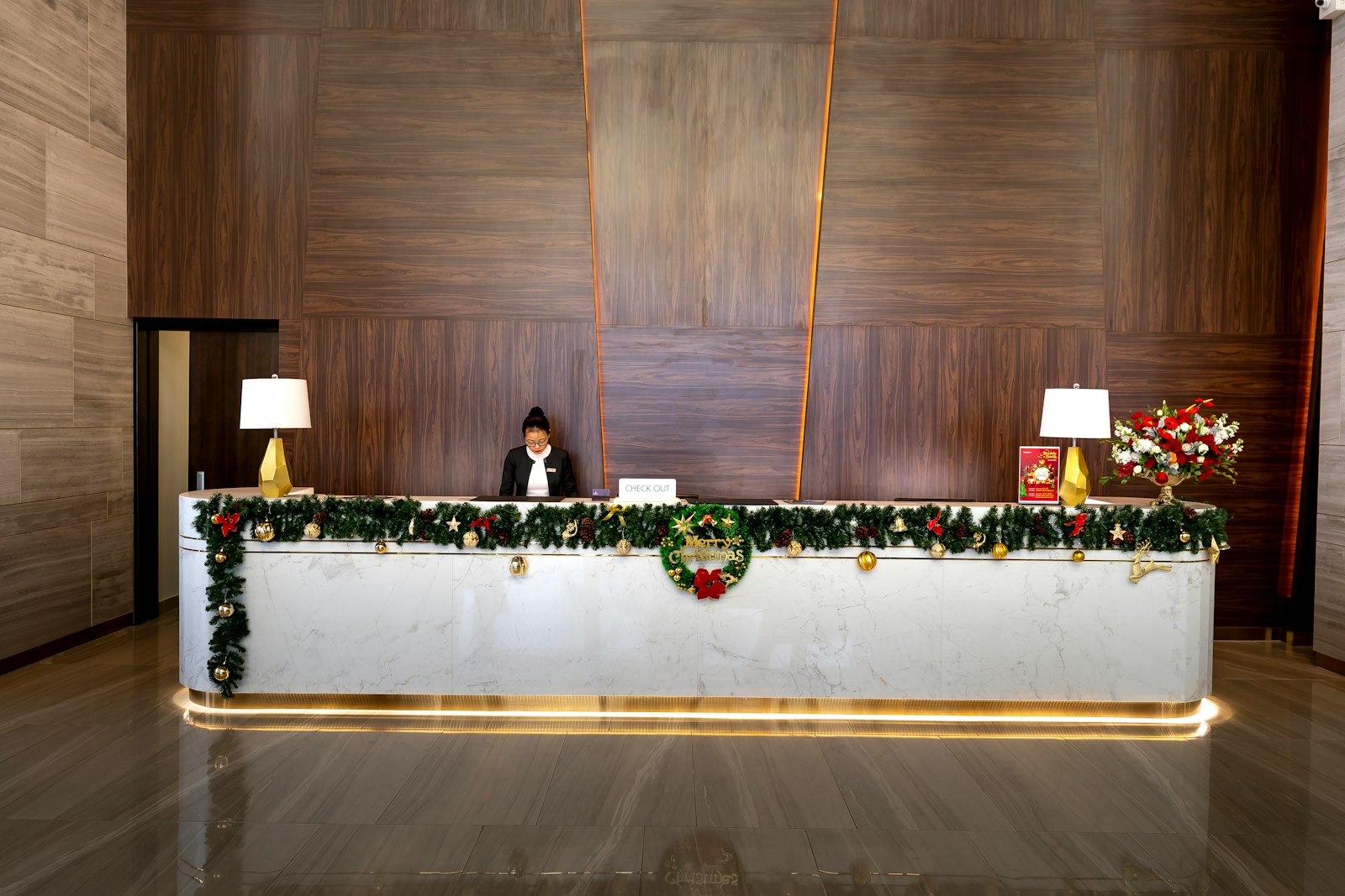 Staff member at a decorated reception counter
