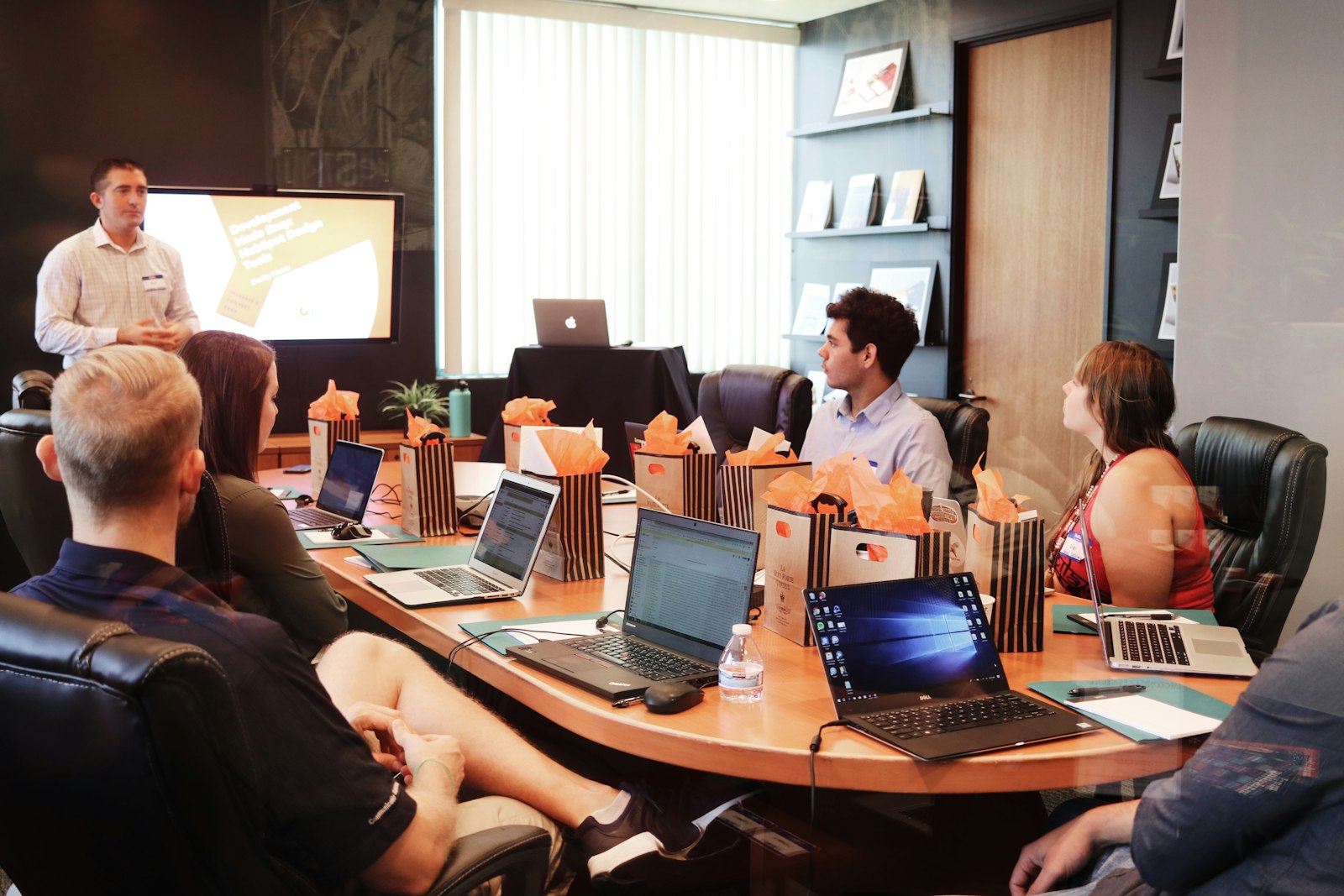Trainer presenting to a team seated around a table