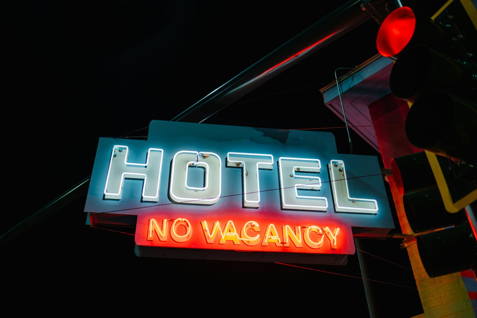 A neon sign reading hotel and no vacancy at night