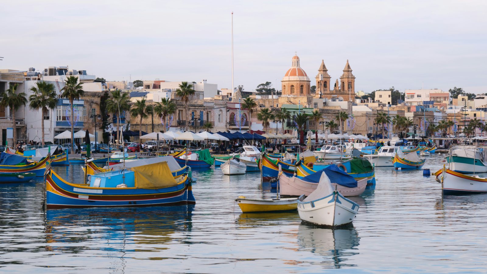 Colourful traditional boats moored in the harbour at Marsaxlokk, Malta